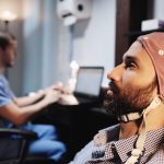 Medical staff performing an EEG on a patient inside the lab of a university clinic. Electroencephalogram test on psychiatric patient performed by doctors. People and professionals in medical industry